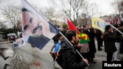 Demonstrators wave flags with the image of imprisoned Kurdish rebel leader Abdullah Ocalan during a rally in Istanbul, Feb. 15, 2015. 