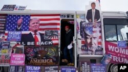 FILE - An RV, that is parked outside Team Trump New Hampshire headquarters, is visited by supporters, January 20, 2024, in Manchester, NH.