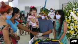  Indigenous people from the Parque das Tribos community mourn besides the coffin of Chief Messias, 53, of the Kokama tribe who died of COVID-19, in Manaus, Brazil, on May 14, 2020.