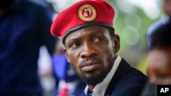 Presidential challenger Bobi Wine speaks to the media outside his home, in Magere, near Kampala, Uganda, Jan. 26, 2021. 