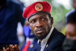 Presidential challenger Bobi Wine speaks to the media outside his home, in Magere, near Kampala, Uganda, Jan. 26, 2021.