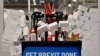 Britain&#39;s Prime Minister Boris Johnson drives a JCB through a symbolic wall with the Conservative Party slogan &#39;Get Brexit Done&#39; in the digger bucket, during an election campaign event at the JCB manufacturing facility in Uttoxeter, England.