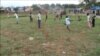 A boy takes a shot at an unseen goal on a barren field in a Juba suburb that South Sudanese children have turned into a field of football dreams.