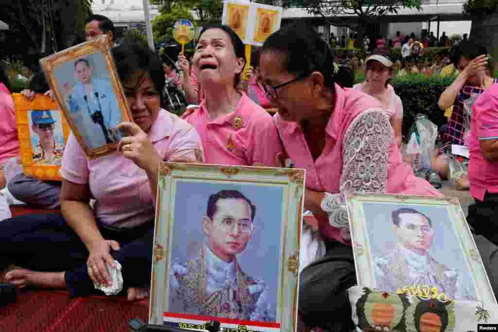 Well-wishers weep as they pray for Thailand's King Bhumibol Adulyadej at the Siriraj hospital where he was being attended to before his death, in Bangkok, Thailand. King Bhumibol Adulyadej has died after a long illness, the palace announced, ending a remarkable seven-decade reign and leaving a divided people bereft of a towering and rare figure of unity.