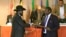 FILE - South Sudan's President Salva Kiir, left, and South Sudan's rebel commander Riek Machar exchange documents after signing a cease-fire agreement during an Inter Governmental Authority on Development (IGAD) Summit in Addis Ababa, Ethiopia.