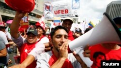 FILE - Backers of Venezuela's President Nicolas Maduro take part in a rally to support him in Caracas, Oct.18, 2014. 