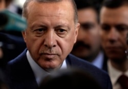 Turkish President Recep Tayyip Erdogan speaks to journalists in Ankara, Feb. 19, 2020.