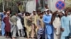 Afghans line up outside a bank to take out their money after the Taliban takeover in Kabul, Afghanistan, Sept. 1, 2021. 