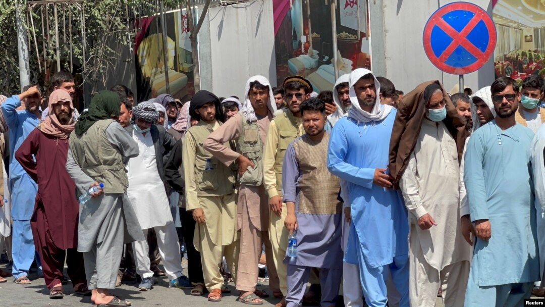 Afghans line up outside a bank to take out their money after the Taliban takeover in Kabul, Afghanistan, Sept. 1, 2021. 