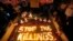 FILE - Human rights activists light candles for the victims of extrajudicial killings around the country in the wake of the "war on drugs" campaign by Philippine President Rodrigo Duterte in suburban Quezon city northeast of Manila, Philippines. 