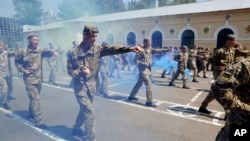 FILE - Graduate cadets give a demonstration during a graduation ceremony at the military lyceum in Kyiv, Ukraine, May 31, 2019. 