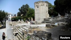 Tourists visit the Tower of the Winds, open to the public for the first time in more than 200 years after being restored, in the Roman Agora, in Plaka, central Athens, Greece, Aug. 23, 2016. 