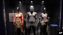 Marvel MoPOP ExhibiIn this photo taken April 18, 2018, costumes worn by Black Panther characters, from left, Okoye, Black Panther and Shuri, are displayed during a preview of the exhibit Marvel: Universe of Super Heroes at the Museum of Pop Culture, in Se
