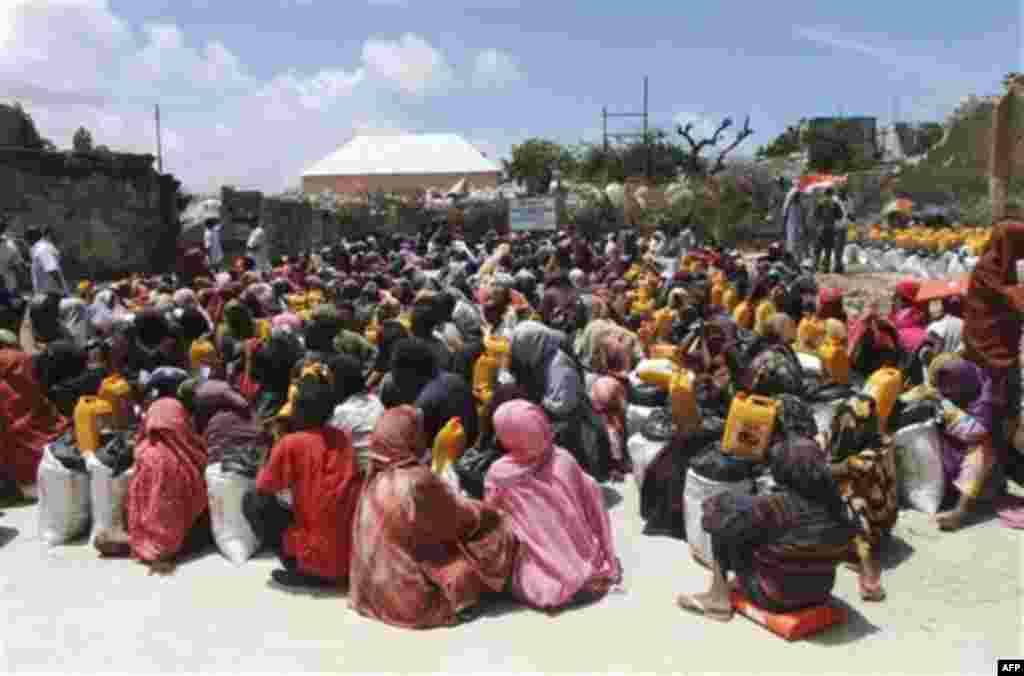 Somalis from southern Somalia receive food distributed by the Muslim Aid Organization in Mogadishu, Somalia, Thursday, Aug. 4, 2011. The United Nations says famine will probably spread to all of southern Somalia within a month and force tens of thousands 