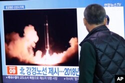 FILE - A man watches a TV screen showing a file image of North Korea's missile launch during a news program at the Seoul Railway Station in Seoul, South Korea, Jan. 1, 2020.