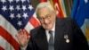 (FILES) Former US Secretary of State Henry Kissinger waves after receiving an award during a ceremony at the Pentagon honoring his diplomatic career May 9, 2016 in Washington, DC.