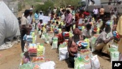 FILE - Men deliver aid donations from donors in Aslam, Hajjah, Yemen, Sept. 23, 2018.