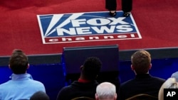 FILE - The Fox News channel logo is seen during a town hall meeting, in Milwaukee, Wisconsin, May 8, 2019.