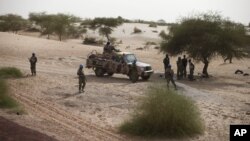FILE - United Nations peacekeepers patrol on the outskirts of Timbuktu, Mali, July 23, 2013.