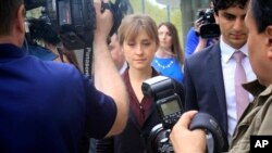 Actress Allison Mack (C) leaves after a hearing at Brooklyn Federal Court, May 4, 2018, in New York. 