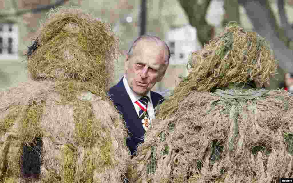 His Royal Highness Prince Philip, Duke of Edinburgh, speaks to sniper team members of 3rd Battalion of The Royal Canadian Regiment at Queen&#39;s Park in Toronto, Ontario.