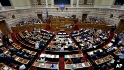 FILE - Greece's Prime Minister Alexis Tsipras delivers a speech during an emergency parliament session in Athens, July 23, 2015