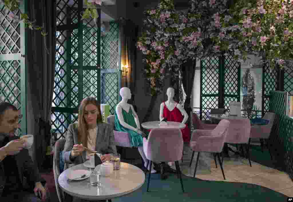 Mannequins are placed to provide social distancing at a restaurant in Vilnius, Lithuania, Thursday, May 21, 2020. (AP Photo/Mindaugas Kulbis)