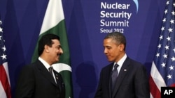 U.S. President Barack Obama (R) shakes hands with Pakistan's Prime Minister Yusuf Raza Gilani during their bilateral meeting on the sidelines of the Nuclear Security Summit in Seoul, March 27, 2012.