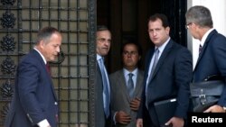 European Central Bank Executive Board member Benoit Coeure (L), Greece's Prime Minister Antonis Samaras (2nd L) and European Central Bank Mission Chief for Greece Klaus Masuch (R) talk after a meeting at the Prime minister's office in Athens, August 28, 2014.