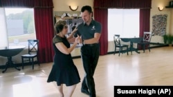In this October 7, 2019, photo, dance instructor Ned Pavlovic, a native of Serbia, teaches his student Rouhy Yazdani, a native of Iran who now lives in Milford, Connecticut, some ballroom dance moves at the Fred Astaire Dance studio in Orange, Connecticut.