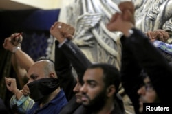 Journalists gesture in protest against the arrests of fellow journalists during a news conference on World Press Freedom Day at the Egyptian press syndicate's headquarters in downtown Cairo, Egypt, May 3, 2016.