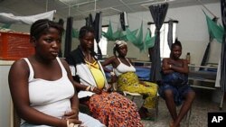 Pregnant women watch television as they wait in the prenatal ward at a maternity hospital in Sierra Leone.