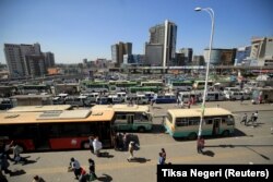 People walk through Megenagna neighborhood bus station in Addis Ababa, Ethiopia November 3, 2021. REUTERS/Tiksa Negeri