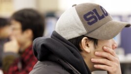 FILE - Young Japanese people search for jobs at an employment agency in Tokyo February 25, 2005.