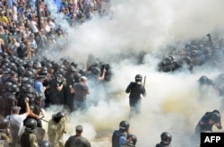 FILE - Smoke rises near the parliament building in Kiev as activists of radical Ukrainian parties, including the Ukrainian nationalist party Svoboda (Freedom), clash with police officers on August 31, 2015.
