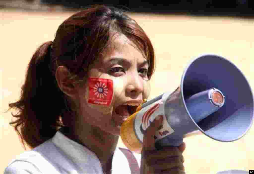 A Myanmar worker uses a loudspeaker to shout slogans as she takes part in a May Day street march in Yangon, Myanmar, May 1, 2015.