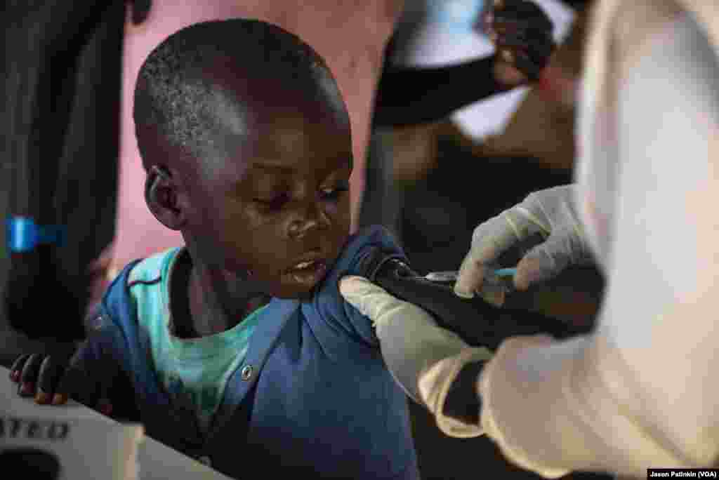 At a reception center, South Sudanese refugees receive basic vaccinations.