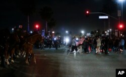 Protesters crowd the street after a rally for Republican presidential candidate Donald Trump, Thursday, April 28, 2016.