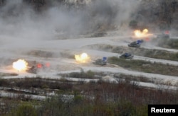FILE - South Korean Army K1A1 and U.S. Army M1A2 tanks fire live rounds during a U.S.-South Korea joint live-fire military exercise, at a training field, near the demilitarized zone, separating the two Koreas in Pocheon, South Korea, Apr. 21, 2017.