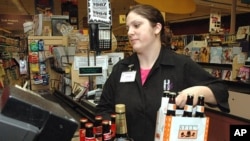 A cashier at Holiday Market, in Royal Oak, Michigan, rings up alcohol purchases, May 3, 2005. 