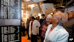 In this Nov. 10, 2017 image, Ellie Dahmer, foreground, wife of Vernon Dahmer of Hattiesburg, who was killed in 1966 by the Ku Klux Klan, their daughter Bettie Dahmer, and an older brother Harold, right at the Mississippi Civil Rights Museum.