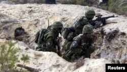 Estonian soldiers take part in NATO military exercise Hedgehog 2015 at the Tapa training range in Estonia, May 12, 2015. 