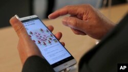 A man checks the Huawei Honor 5X during Mobile World Congress wireless show in Barcelona, Spain, last year.