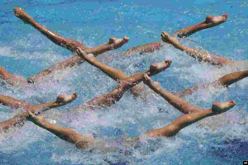 A Ukrainian team performs their Free Routine during the Synchronized Swimming Olympic Games Qualification Tournament at the Maria Lenk Aquatics Center in Rio de Janeiro, Brazil.