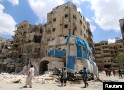 People inspect the damage at al-Quds hospital after it was hit by airstrikes, in a rebel-held area of Syria's Aleppo, April 28, 2016.