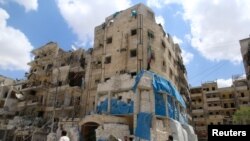 People inspect the damage at al-Quds hospital after it was hit by airstrikes, in a rebel-held area of Syria's Aleppo, April 28, 2016.