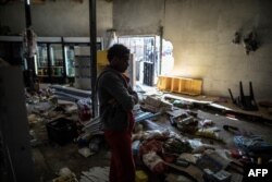 An Ethiopian owner of a looted grocery store stands in his ransacked shop, in Soweto, Johannesburg, South Africa, Aug. 29, 2018.