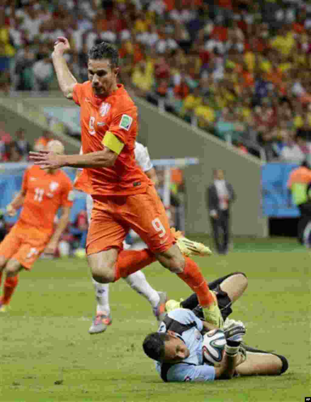 Netherlands' Robin van Persie is sent flying as Costa Rica's goalkeeper Keylor Navas saves at this feet during the World Cup quarterfinal soccer match between the Netherlands and Costa Rica at the Arena Fonte Nova in Salvador, Brazil, Saturday, July 5, 20