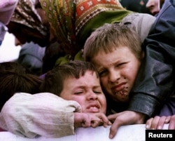 FILE - Bosniak refugees being evacuated from besieged Srebrenica in 1993 as part of a negotiated agreement.