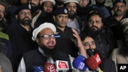 FILE - Hafiz Muhammad Saeed, leader of the Jamaat-ud-Dawa group, or JUD, addresses his supporters in Lahore, Pakistan, Jan. 30, 2017.